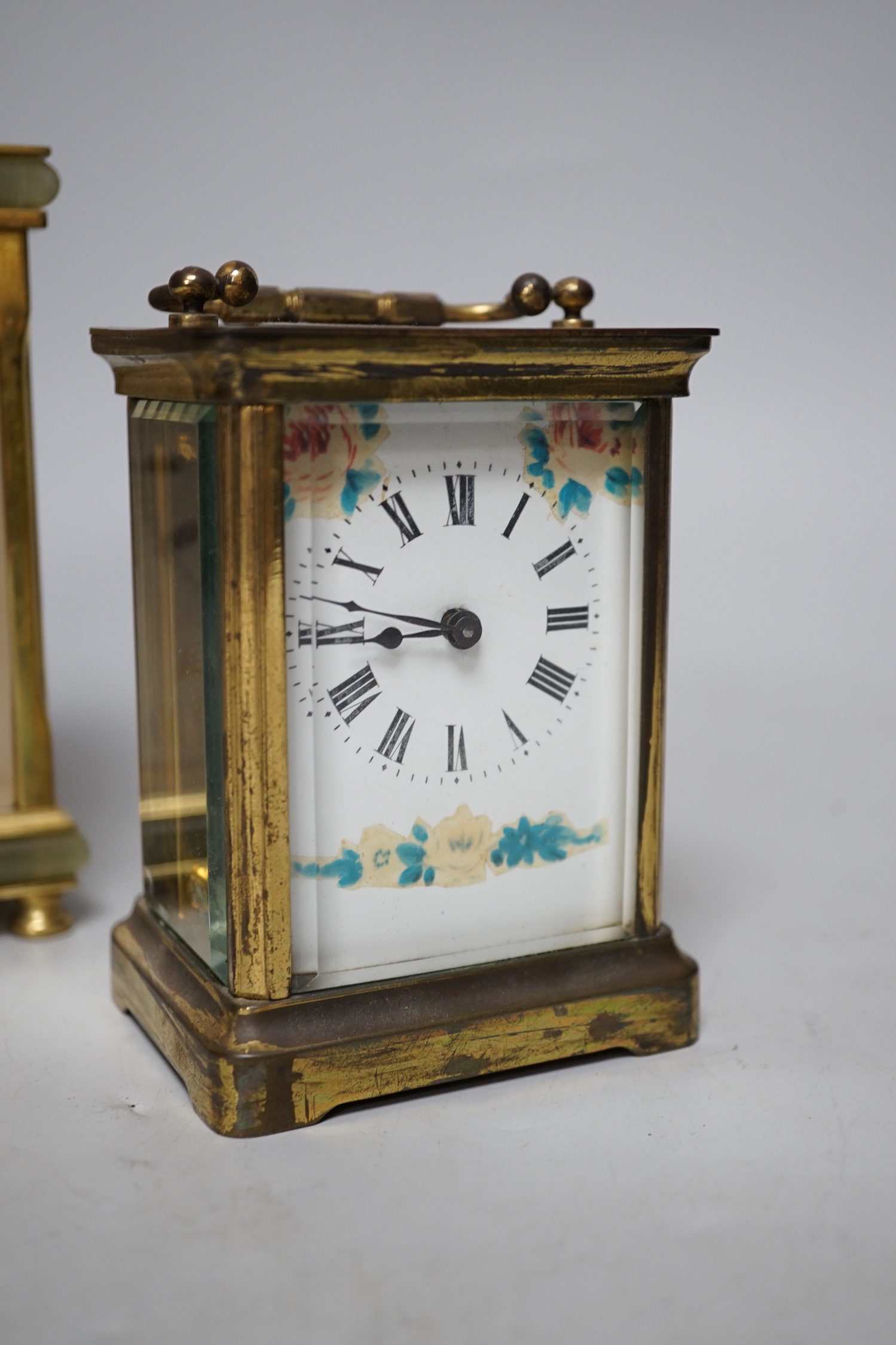 Two carriage timepieces comprising a brass example and one green onyx mounted with quartz movement, largest 17cm high